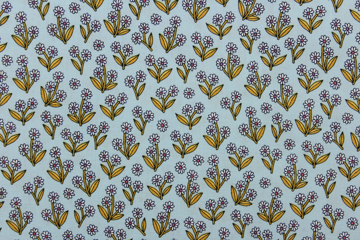 A beautiful white daisy design set against a pale blue gray background.