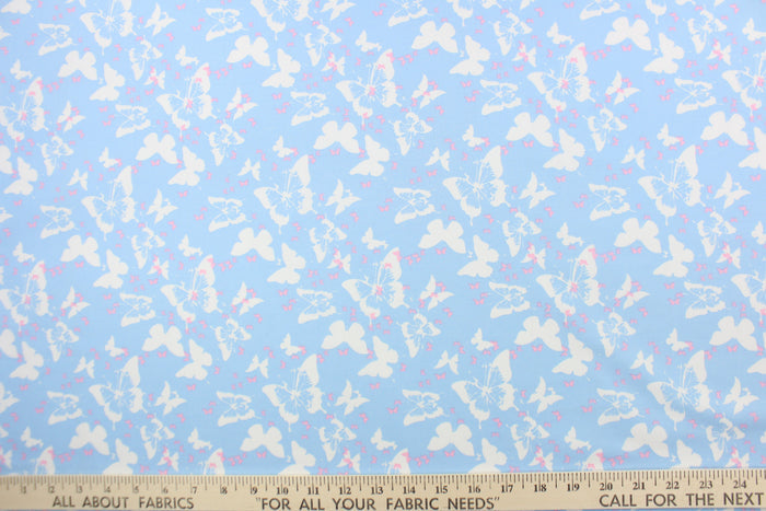 Think of a warm, sunny, summer day with this fabric featuring large and small butterflies in pink and white on a baby blue background.  The versatile lightweight fabric is soft and easy to sew.  It would be great for quilting, crafting and sewing projects.