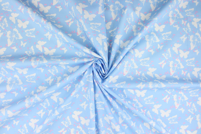 Think of a warm, sunny, summer day with this fabric featuring large and small butterflies in pink and white on a baby blue background.  The versatile lightweight fabric is soft and easy to sew.  It would be great for quilting, crafting and sewing projects.