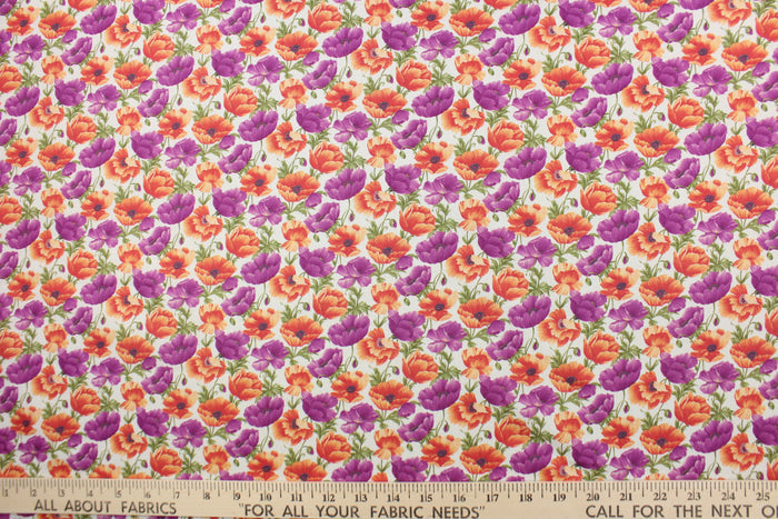From the "Cats N Quilts" collection, Poppies in Bloom features large, vibrant poppy flowers in purple and orange on a white background.  The versatile lightweight fabric is soft and easy to sew.  It would be great for quilting, crafting and sewing projects.