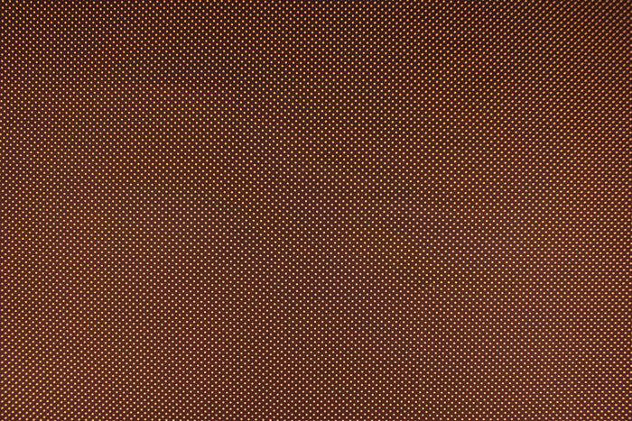 This fabric features small orange polka dots on a brown background.  The versatile lightweight fabric is soft and easy to sew.  It would be great for quilting, crafting and sewing projects.