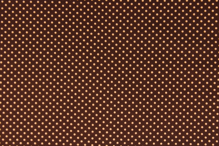 This fabric features small orange polka dots on a brown background.  The versatile lightweight fabric is soft and easy to sew.  It would be great for quilting, crafting and sewing projects.