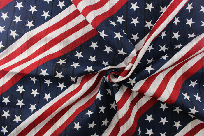 This fabric features an American flag in a diagonal direction with a wood grain look.