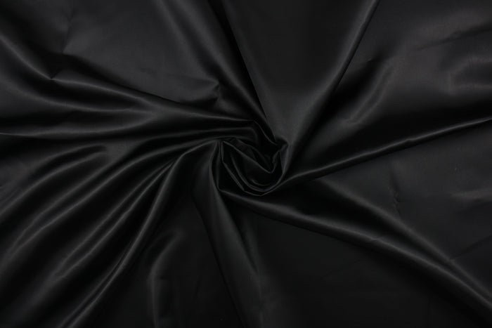 A beautiful satin fabric in a black color.