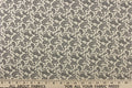 A fun paisley design in basic colors of  black set against a cream background.