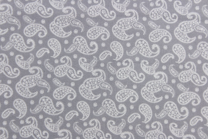 This fabric features a paisley design in white set against a gray background.