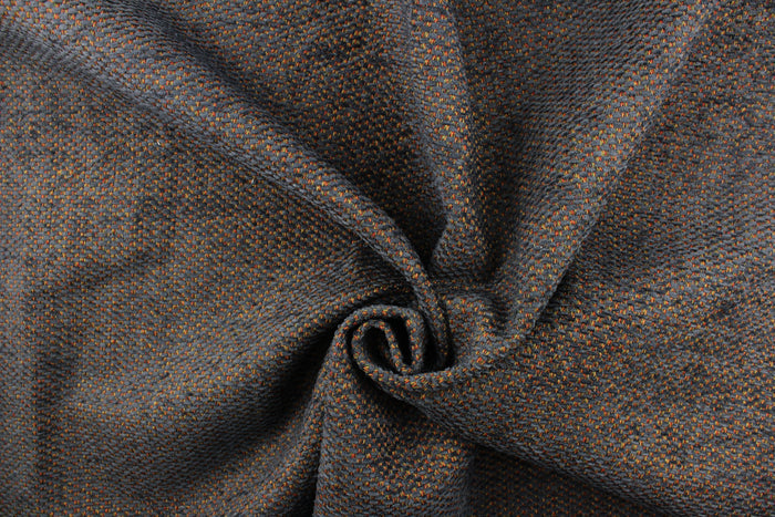 This hard wearing, textured chenille fabric in navy blue with red and gold accents would be a beautiful addition to your home decor.