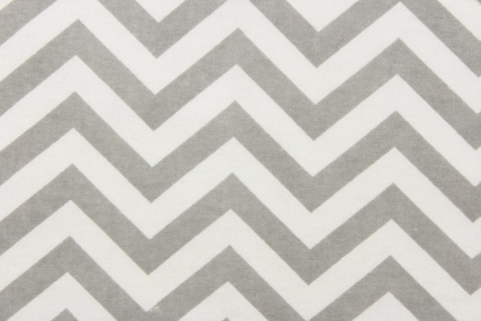 This printed flannel features a chevron pattern in grey and white.  Uses include apparel, bedding, pillows, home decor and crafting.  This fabric has a soft workable feel.