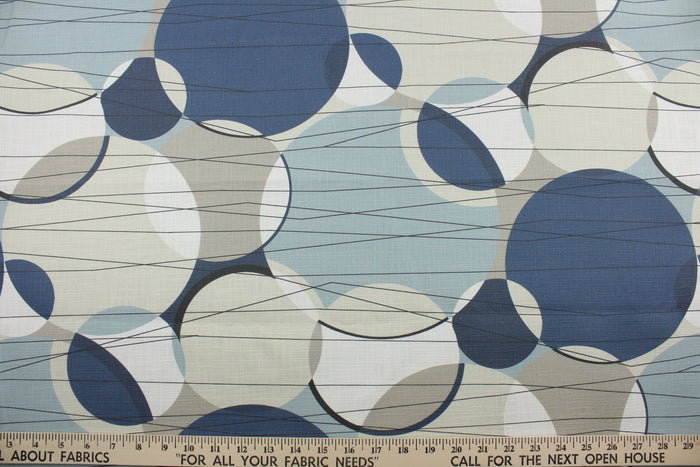 Covington© Ukito in Harbor is a versatile fabric with a contemporary print featuring shades of blue, black, light teal, and creams.  With an impressive 50,000 double rub count, this multipurpose fabric is durable and perfect for any project.  The fabric is perfect for window accents (draperies, valances, curtains and swags) cornice boards, accent pillows, bedding, headboards, cushions, ottomans, slipcovers and upholstery.