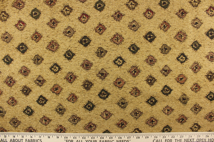 This hard wearing, textured chenille fabric features diamond shapes in green, red, and brown on a desert sand colored background.