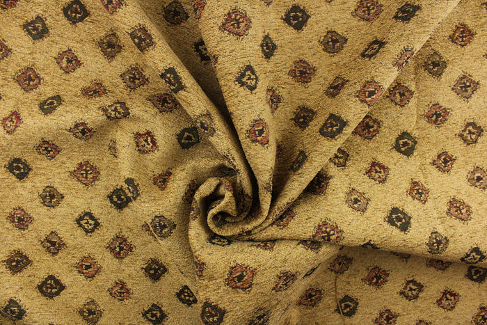 This hard wearing, textured chenille fabric features diamond shapes in green, red, and brown on a desert sand colored background.