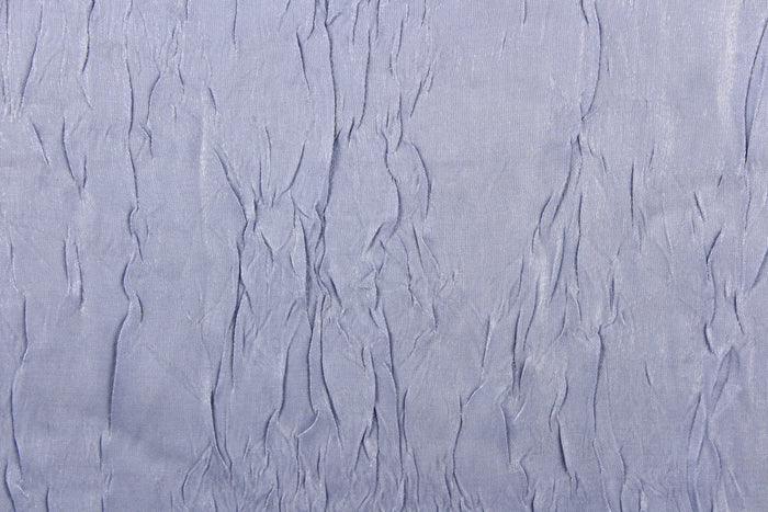 This taffeta fabric features a crinkle in iridescent silver blue color.