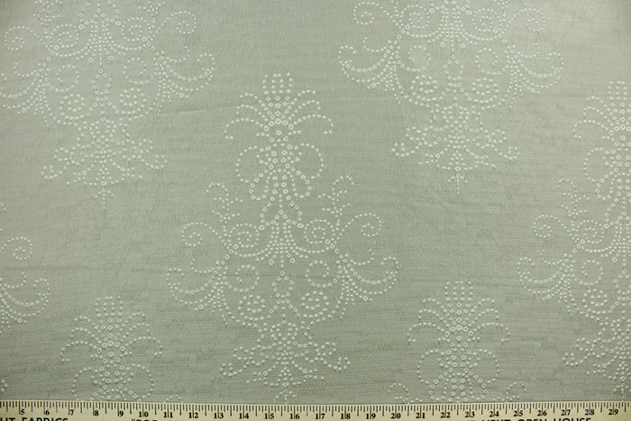 Steel Imprints features a large scale embroidered medallion design in gray.  The embroidered design adds an elegant look to the fabric.  Uses include apparel, decorative pillows, window treatments and bedding.