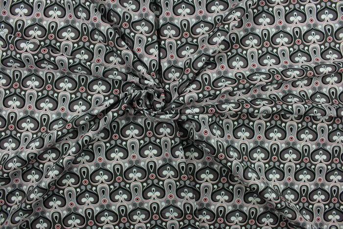 This fabric features an abstract design in red, gray, black and white.  The lightweight fabric is easy to sew and has a soft hand.  The versatile fabric makes it great for quilting, crafting and home décor.