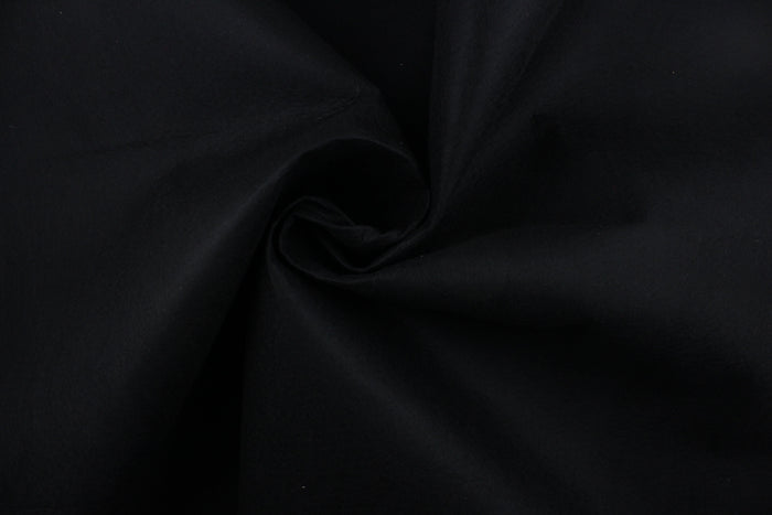 This is a felt fabric in solid black.  It features a slightly textured feel that is soft, sturdy and durable.  Uses include crafts, apparel accents, décor, embellishments and more.