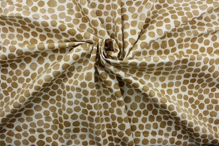 Puff Dotty is an indoor-and-outdoor upholstery fabric with a soil-and-stain repellant finish.  It features golden brown dots on a cream background, screen printed for lasting quality and beauty.  With 51,000 double rubs, it stands up to frequent use, making it great for throw pillows, chair cushions, table top accessories, tote bags, and more.