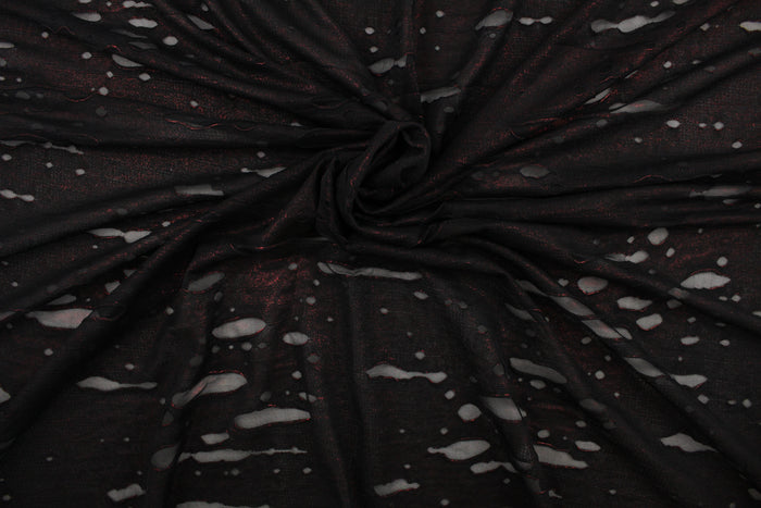 This stretch lycra blend fabric in black with undertones of red.