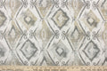 This jacquard features a diamond design in varying shades of gray and taupe .
