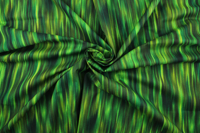 This fabric features stripes in varying shades of green with hints of black that blend together to create a beautiful color palette.  It has a nice soft hand and would be great for quilting, crafting and home decor.  We offer this pattern in several different colors.