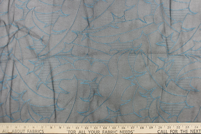 This lace with a unique design in a blue color against a black background .