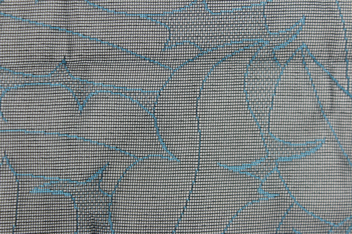 This lace with a unique design in a blue color against a black background .