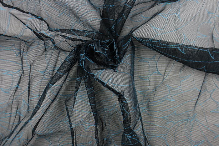 This lace with a unique design in a blue color against a black background .