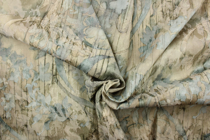 This jacquard fabric features a floral design in turquoise, green, beige, and hints of gray.