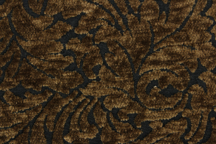 This hard wearing, textured chenille fabric features a unique leaf design in bronze on a black background.