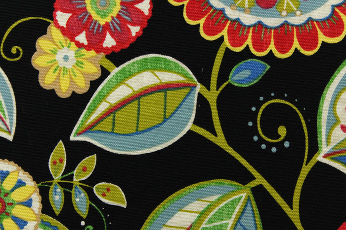 This bright fabric features a funky floral design in vivid colors of red, blue, green, yellow, white, and dark pink against a black background.
