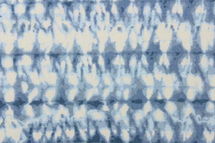 This fabric features an abstract design in varying shades of blue and white.