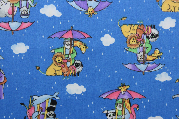 Featuring a classic cartoon print of Noah's Ark, this cheerful design will bring a touch of fun to your home.  An array of bright colors, like pink, purple, yellow, green, black, and white, contrast against a bold blue background, and the addition of clouds, raindrops, and umbrellas make this fabric truly eye-catching.  The high-quality cotton material ensures lasting durability and softness.  It would be great for apparel, quilting, crafting and sewing projects.