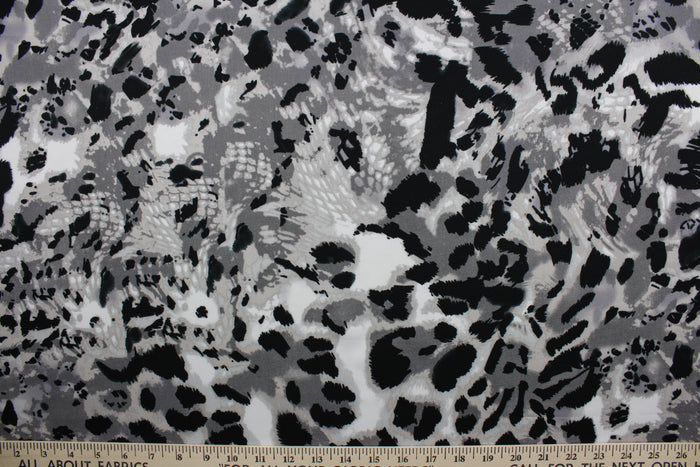 Featuring an eye-catching ocelot print in black, white, shades of gray, and light beige, the unique pattern stands out while the classic colors blend in for a sophisticated and timeless look.  The high-quality cotton material ensures lasting durability and softness.  It would be great for apparel, quilting, crafting and sewing projects.