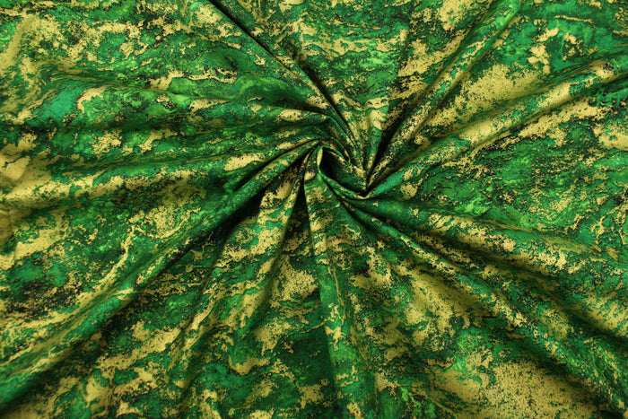 A marble design in varying shades of green and gold with hints of black .