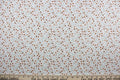 Cicely features an intricate floral pattern in shades of brown, tan, green, and black, set against a white background.  The high-quality cotton material ensures lasting durability and softness.  It would be great for apparel, quilting, crafting and sewing projects.
