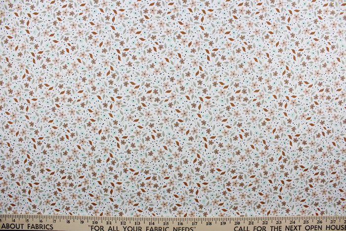 Cicely features an intricate floral pattern in shades of brown, tan, green, and black, set against a white background.  The high-quality cotton material ensures lasting durability and softness.  It would be great for apparel, quilting, crafting and sewing projects.