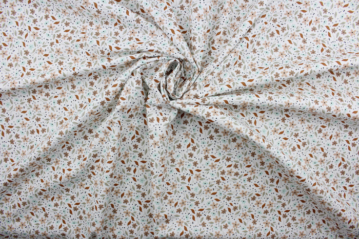 Cicely features an intricate floral pattern in shades of brown, tan, green, and black, set against a white background.  The high-quality cotton material ensures lasting durability and softness.  It would be great for apparel, quilting, crafting and sewing projects.
