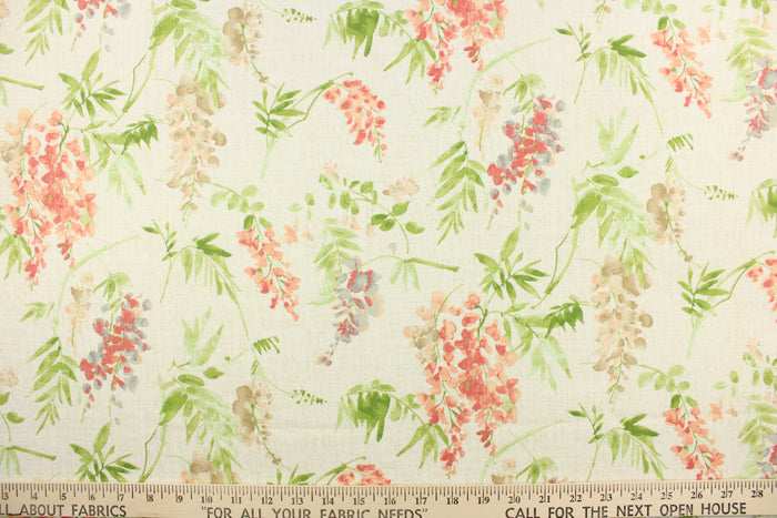 This fabric features a floral design in pink, blue , beige, green, and peach against a off white  background.
