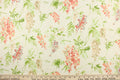 This fabric features a floral design in pink, blue , beige, green, and peach against a off white  background.