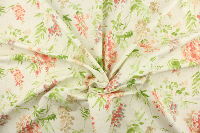 This fabric features a floral design in pink, blue , beige, green, and peach against a off white  background.