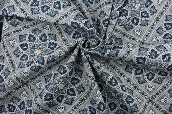 The Richloom Solarium© Medallion in Greystone features a unique geometric medallion print in a palette of grey, blue, and cream tones, making it a perfect choice for any outdoor space.  This versatile, long-lasting fabric can withstand up to 500 hours of sunlight, water and stain resistant and has 10,000 double rubs.  It is perfect for lounge cushions, pool furniture, tablecloths, decorative pillows and upholstery projects.