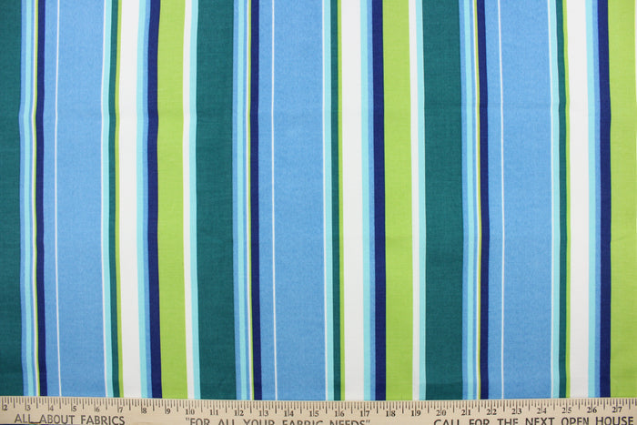 This outdoor fabric features bright stripes in blue, navy blue, lime green, dark green, turquoise, and white.