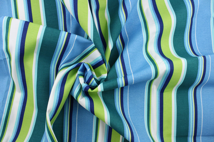This outdoor fabric features bright stripes in blue, navy blue, lime green, dark green, turquoise, and white.
