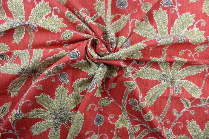 Robert Allen© Indienne Ink in Coral is a multi-purpose fabric featuring palm trees and plants. With a coral background and brown, green, and white accents, it's sure to draw the eye.  It's also incredibly durable, boasting 65,000 double rubs and a soil and stain repellant finish.  It can be used for several different statement projects including window accents (drapery, curtains and swags), toss pillows, headboards, bed skirts, duvet covers, upholstery, and more.
