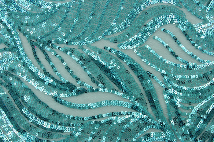 The Sequined Aqua Garden in Sky Blue is expertly crafted with a polyester tulle base and delicate sequins.  Its decorative design brings a touch of whimsy, while the sky blue color creates a calming atmosphere.  Perfect for adding sparkle to special occasion apparel, costumes, overlays, table tops, and decorations.