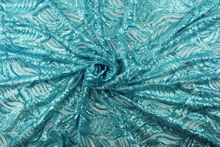 The Sequined Aqua Garden in Sky Blue is expertly crafted with a polyester tulle base and delicate sequins.  Its decorative design brings a touch of whimsy, while the sky blue color creates a calming atmosphere.  Perfect for adding sparkle to special occasion apparel, costumes, overlays, table tops, and decorations.