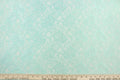 This lace features a floral design in a beautiful mint green with a stretch.