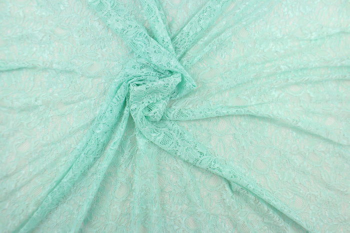 This lace features a floral design in a beautiful mint green with a stretch.