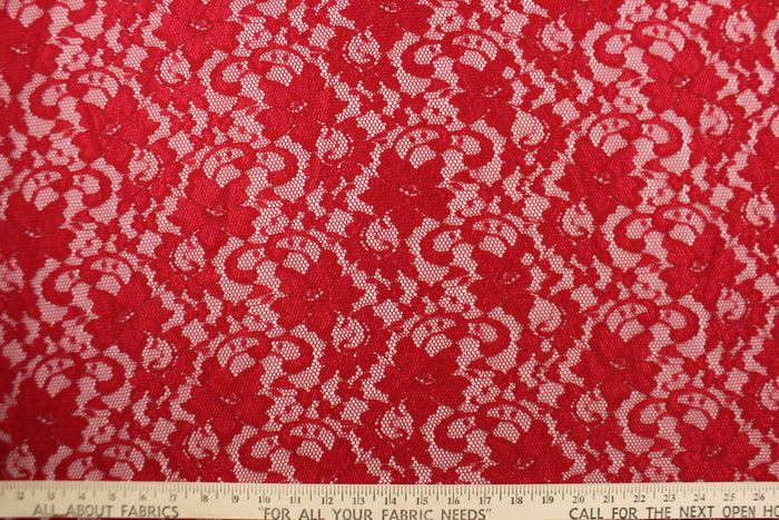 This lace features a floral design in a rich red with a stretch.