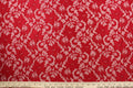 This lace features a floral design in a rich red with a stretch.