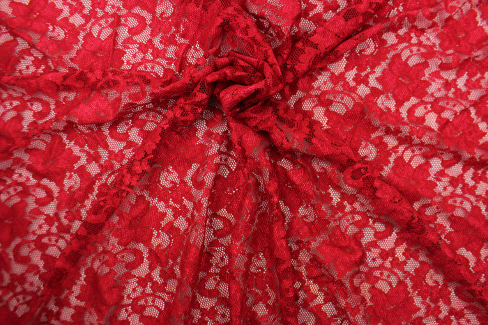 This lace features a floral design in a rich red with a stretch.